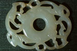 Perforated disc (bi) with exterior rim surrounded by two sinuous chilong