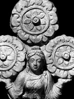 Female figure, holding up a triratna(?)